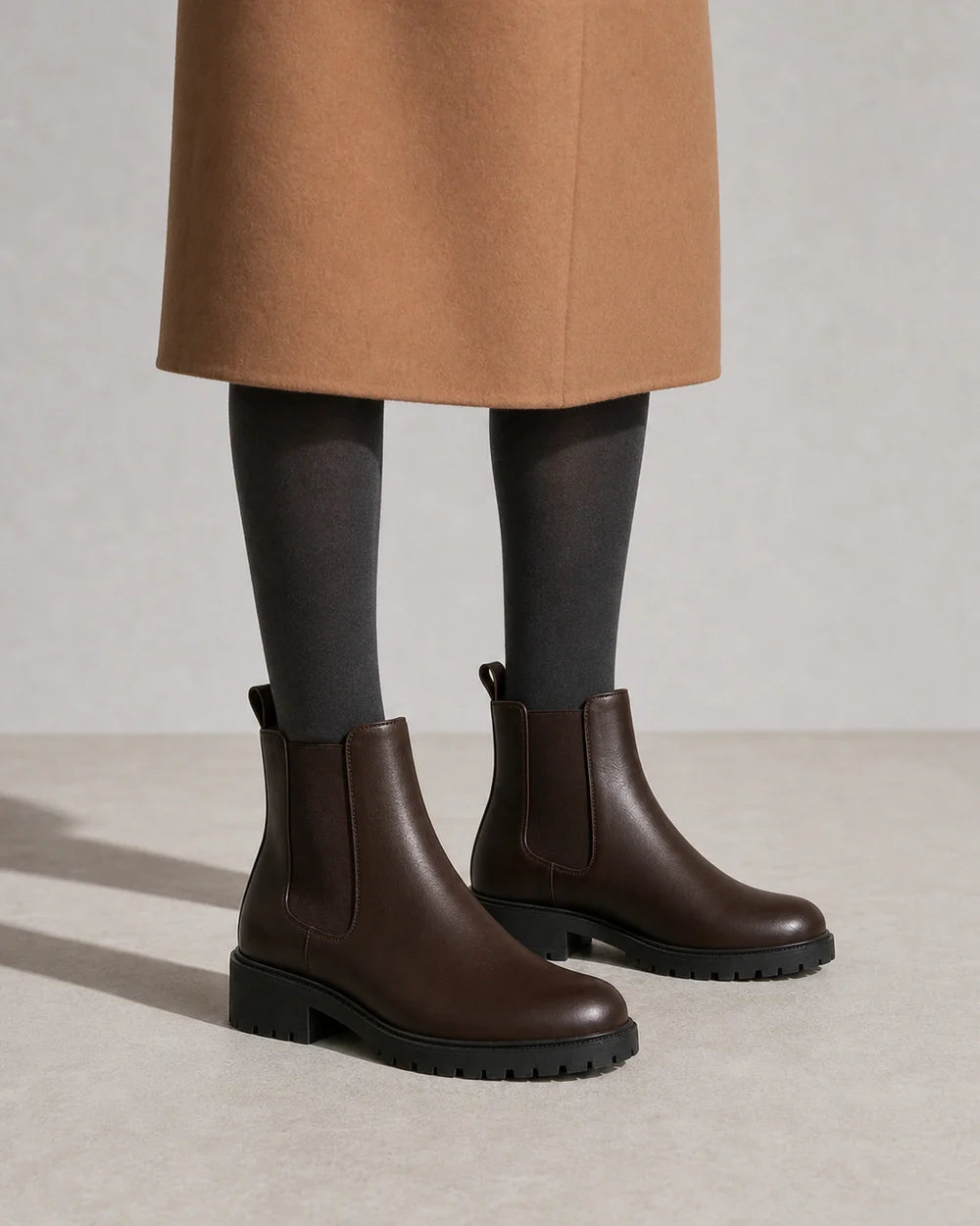 Women's chocolate brown lug-sole Chelsea boots, second styling view.